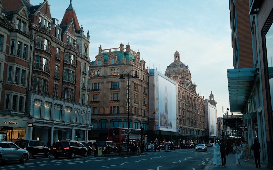 Exterior view of a historic multi-story building with ornate architectural details and a prominent vertical sign reading 'HARRORDS' in gold letters, located on a busy city street. The ground floor fea